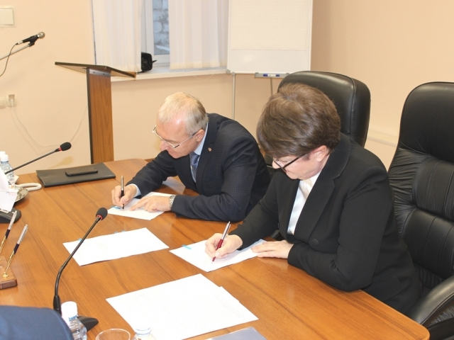 Директор ПАО «Надеждинский металлургический завод» Андрей Удовенко и председатель профсоюзной организации завода Вера Тилькун подписывают Соглашение.